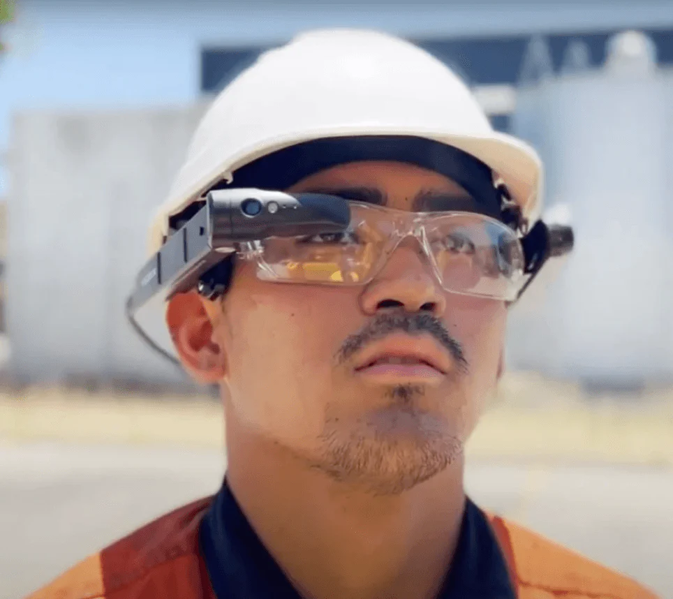 Technician wearing the Vuzix M400 clipped onto safety glasses, with hard hat